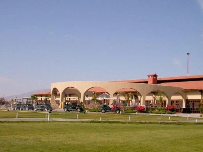 A large building with arches and lawn equipment.